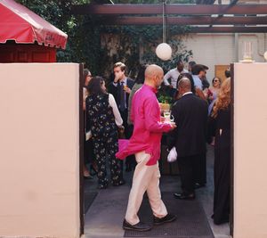 Anil Dash walking through a gate into a party, 2026
